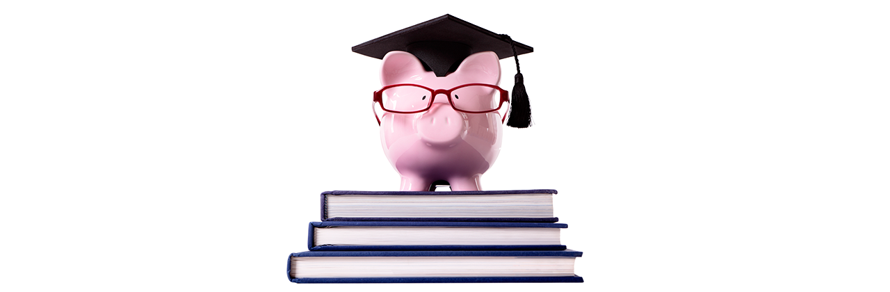 piggy bank with glasses and a grad cap on a pile of textbooks